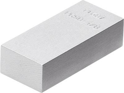 Un bloc métallique rectangulaire avec gravure '11687 TR3B 1/8' sur sa surface lisse.