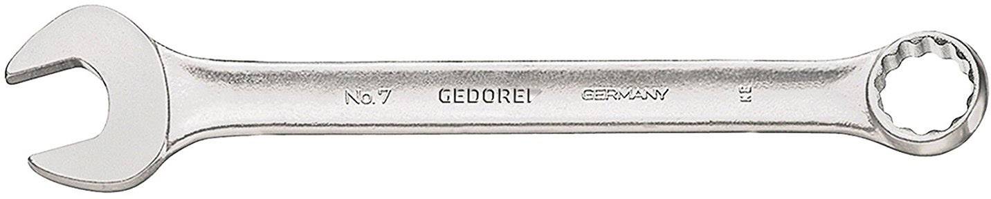 Une clé à molette chromée portant l'inscription 'GEDORE No. 7 GERMANY'. À gauche, une clé plate, à droite, une clé polygonale.