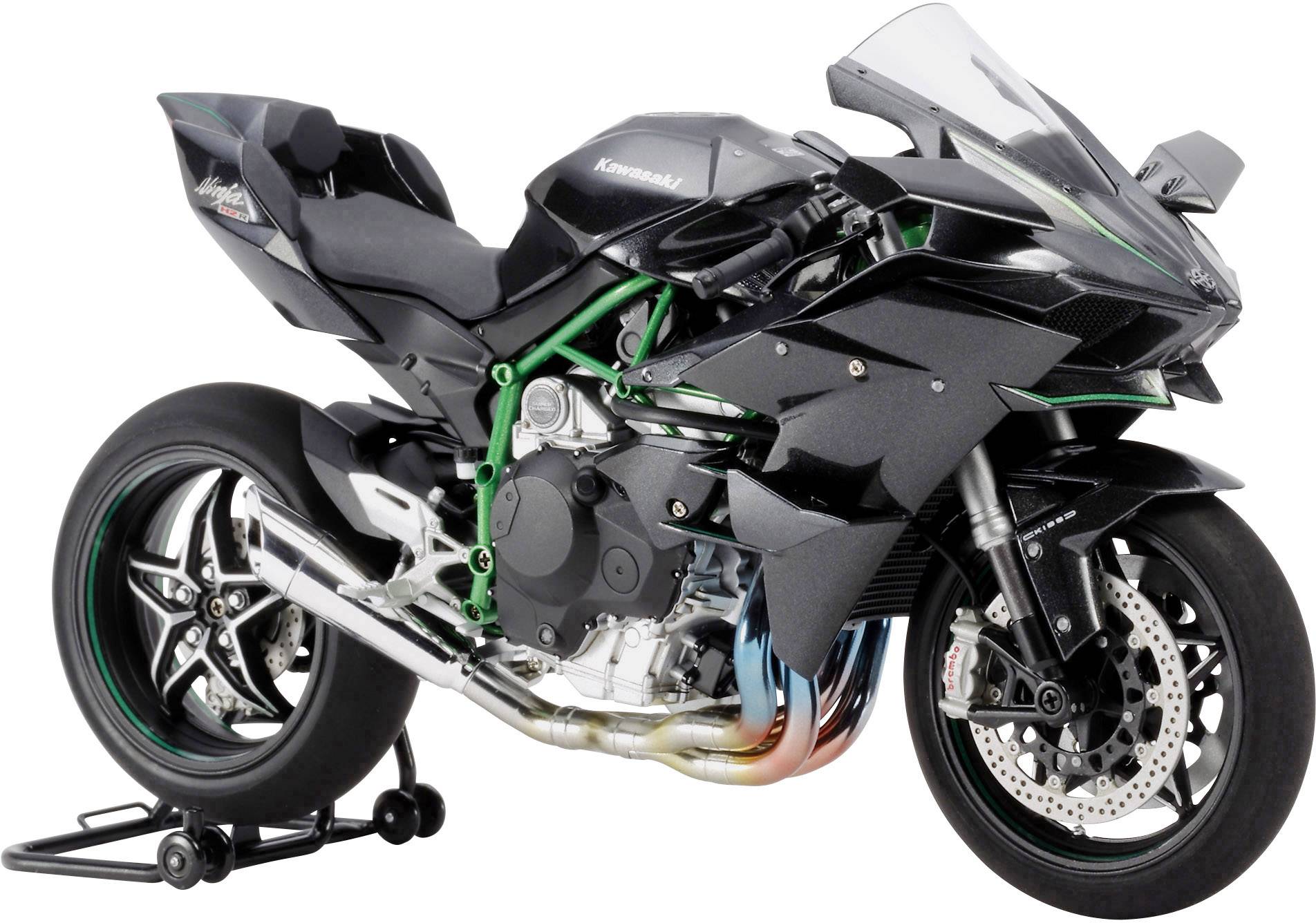 Une moto de sport noire est posée sur un support. Elle présente un style moderne et aérodynamique avec des touches vertes marquantes.