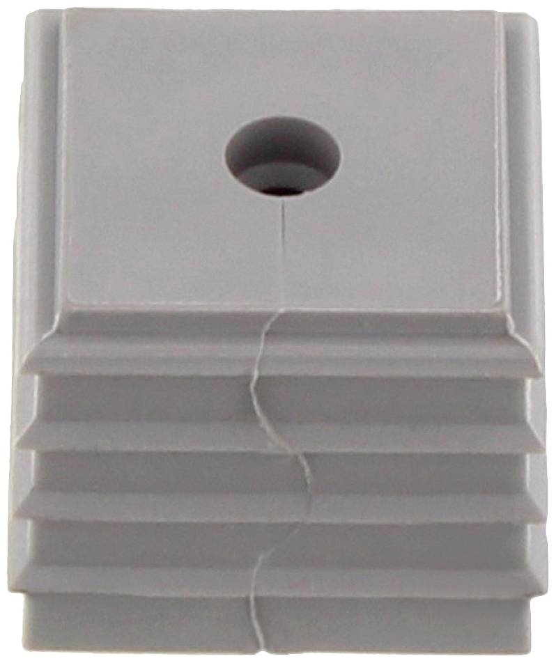 Pièce carrée en plastique grise avec une surface cannelée et un trou en son centre. Elle présente une fissure visible au milieu.
