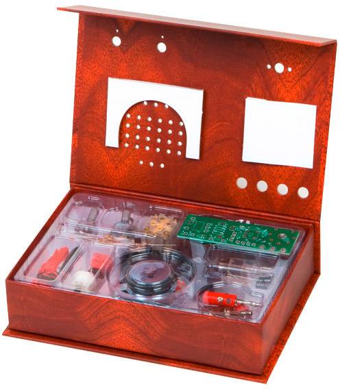 Un kit électronique rouge contenant des composants tels que des cartes de circuit imprimé, des câbles et des outils, dans un boîtier ouvert, destiné à l'apprentissage et au bricolage.