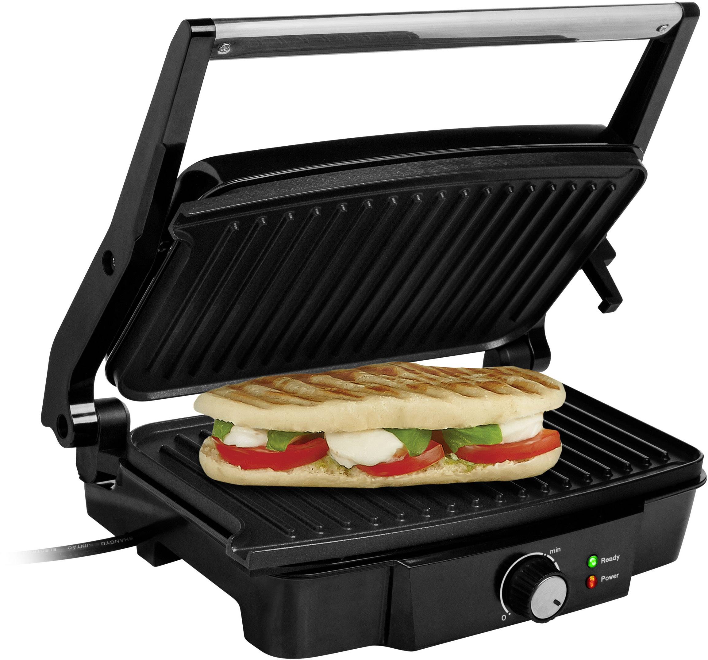 Un grill à sandwich avec un panini grillé, garni de tomates, de mozzarella et de basilic entre les plaques de grill noires.