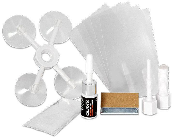 Un kit de réparation de pare-brise comprenant des ventouses, de la colle, des feuilles, des tampons de ponçage, des aiguilles et une notice pour réparer les fissures.