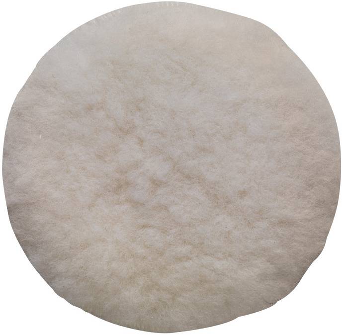 Une surface ronde, duvetée, de couleur crème, semblable à un tampon de polissage doux.