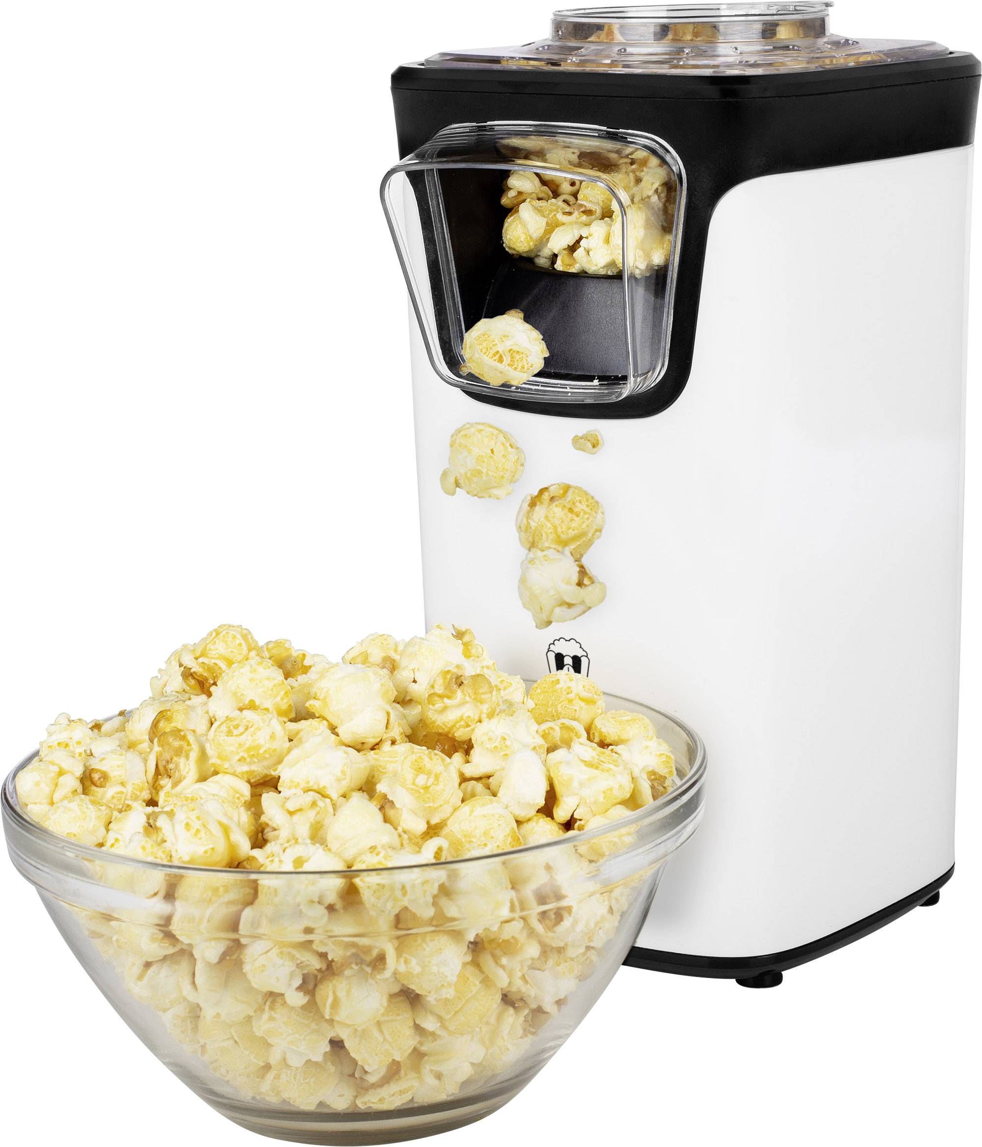 Une machine à pop-corn blanche qui projette du pop-corn dans un bol en verre. Le pop-corn tombe par une trappe de sortie à l'avant de la machine.