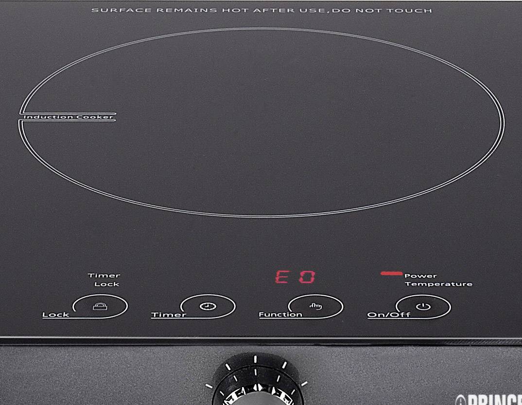 Un plan de cuisson à induction noir avec un affichage numérique rouge indiquant 'E0'. Commandes de minuterie, de fonction et de puissance visibles.