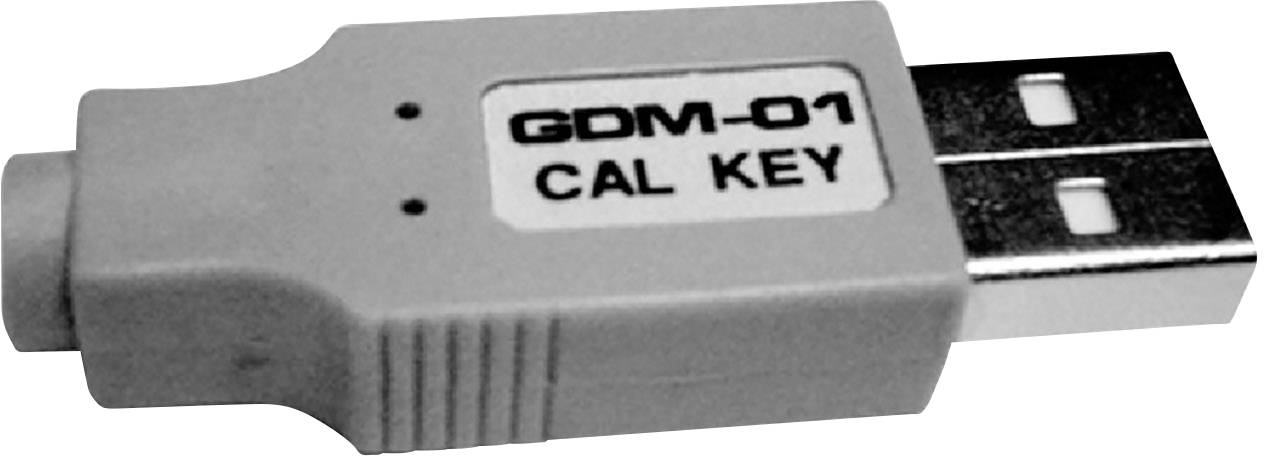 Une clé USB portant l'inscription 'GDM-01 CAL KEY' sur une étiquette blanche, probablement destinée à des fins de calibration.