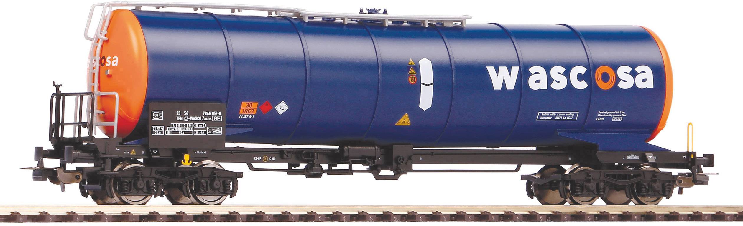 Un wagon-citerne bleu du chemin de fer portant l'inscription 'Wasco' est stationné sur des rails. Les extrémités du wagon-citerne sont orangées.