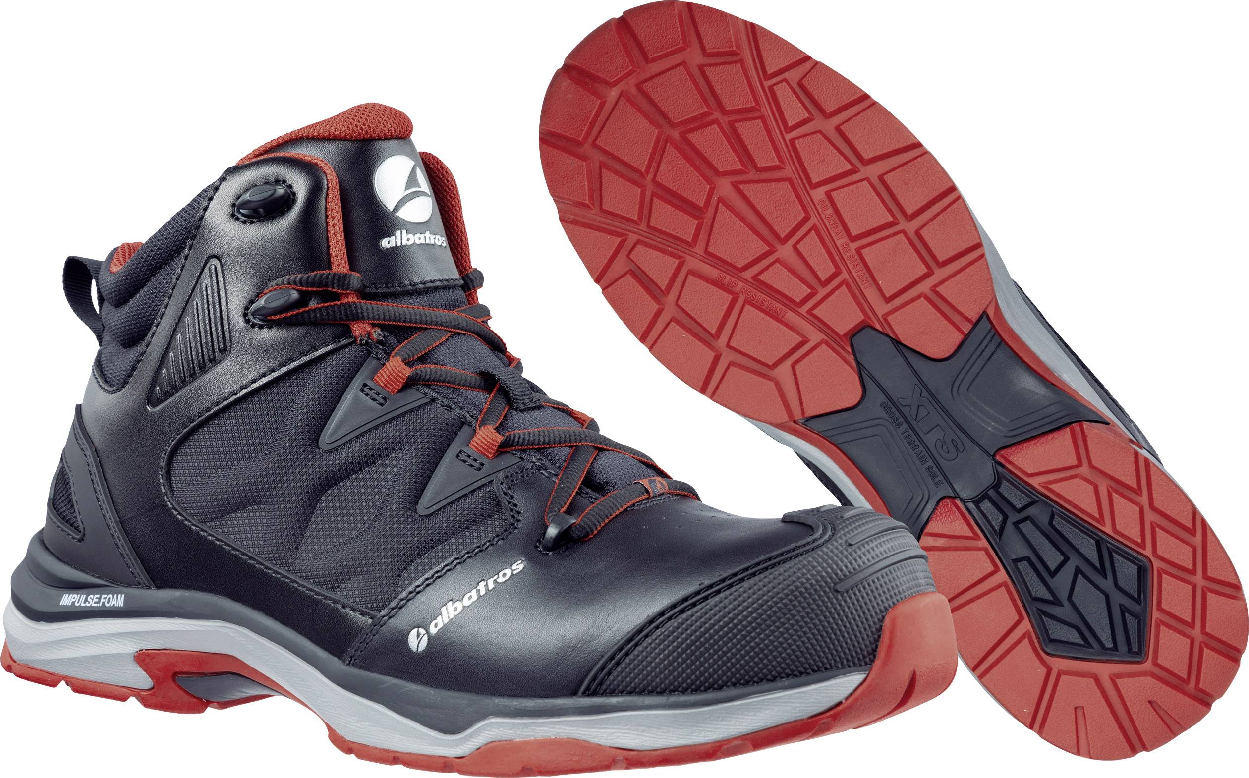 Une chaussure de sécurité noir et rouge avec semelle antidérapante et design robuste, adaptée aux environnements de travail.