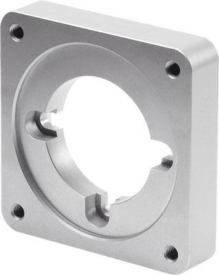 Une pièce rectangulaire en métal avec un trou circulaire au centre et quatre trous aux coins, probablement une pièce de machine.