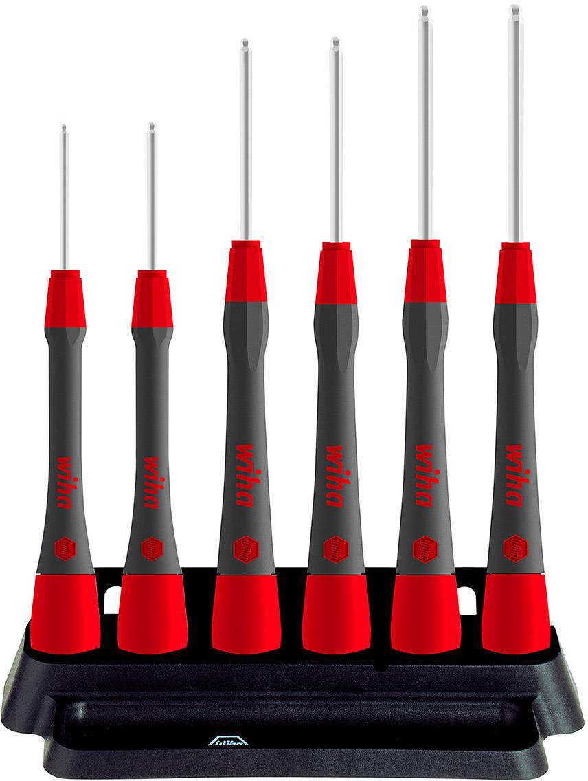 Six tournevis de précision à poignées rouges et noires sont rangés dans un support noir.