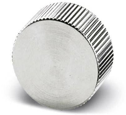 Un aimant rond argenté au bord cannelé est posé sur une surface blanche.