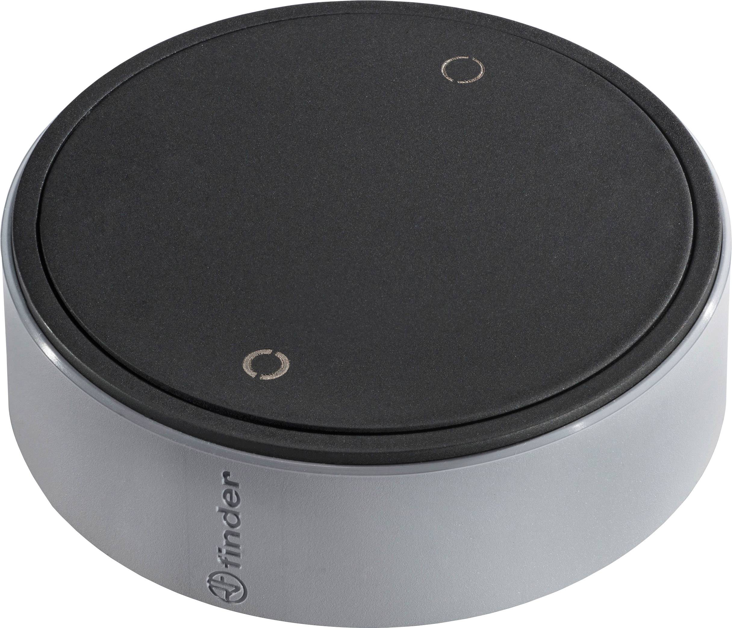 Un variateur rond noir à commande sensorielle de Finder avec bordure argentée, adapté pour contrôler l'intensité lumineuse.