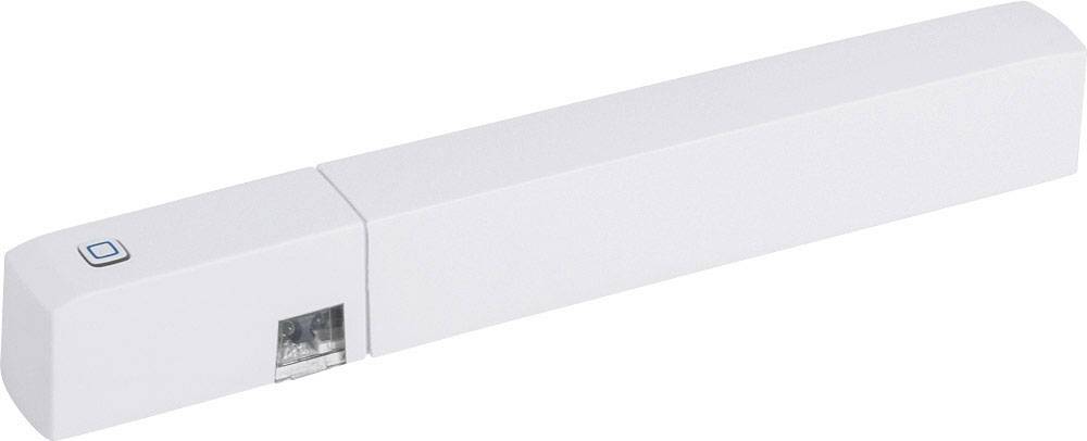 Un capteur blanc, allongé, avec un petit bouton et une section transparente pour les connexions, probablement un détecteur de porte ou de fenêtre.