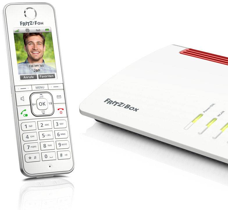 Un téléphone blanc sans fil avec écran affiche une image d'appel. À côté se trouve un routeur Internet blanc doté de plusieurs voyants lumineux.