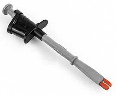 Un adaptateur de test gris avec une poignée noire et des embouts rouges, utilisé dans des applications de mesure électrique.