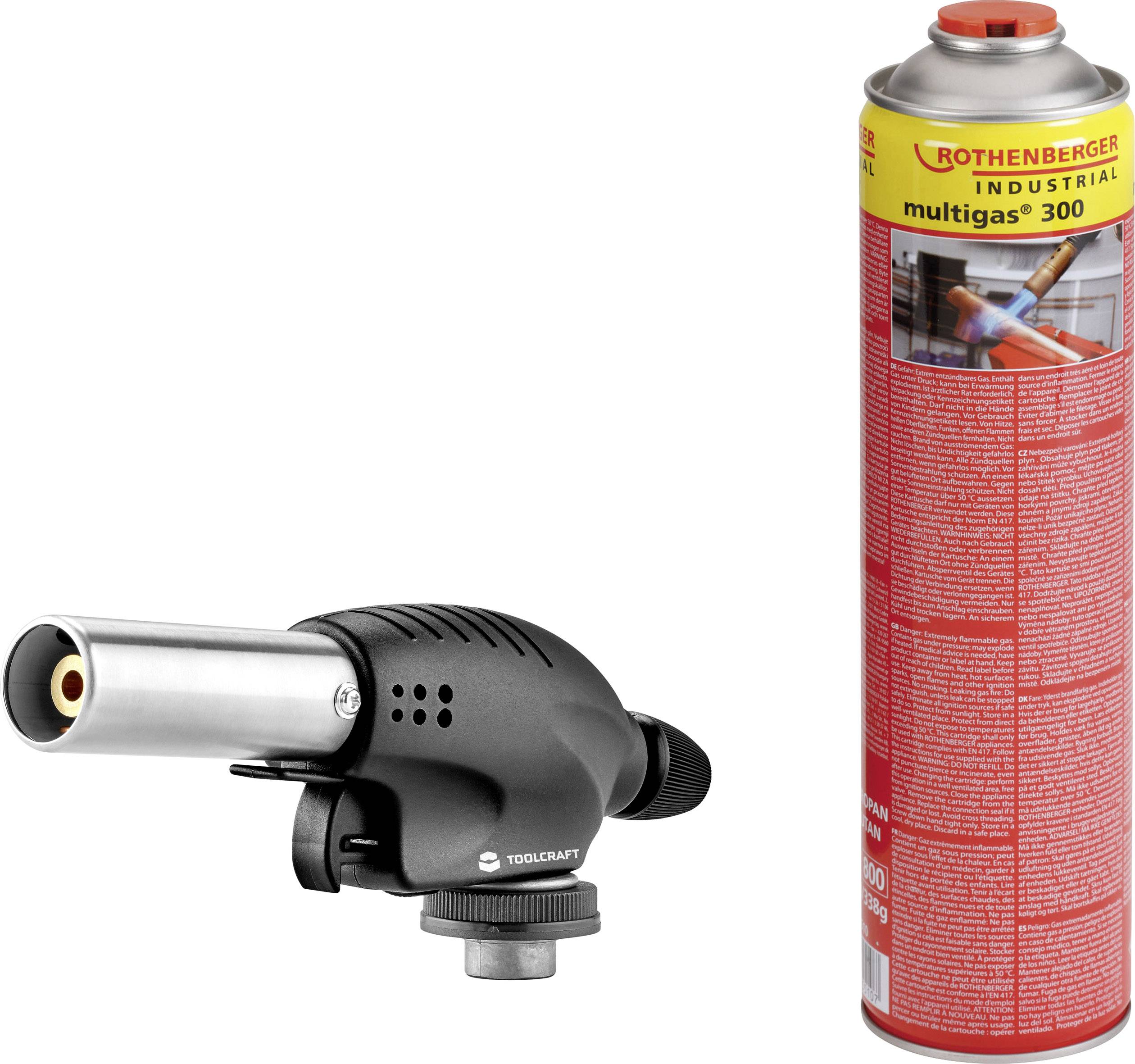 Sur l'image, on voit un brûleur noir à gaz à côté d'une cartouche rouge Multigas-300. Le brûleur est compact et suggère un usage artisanal.