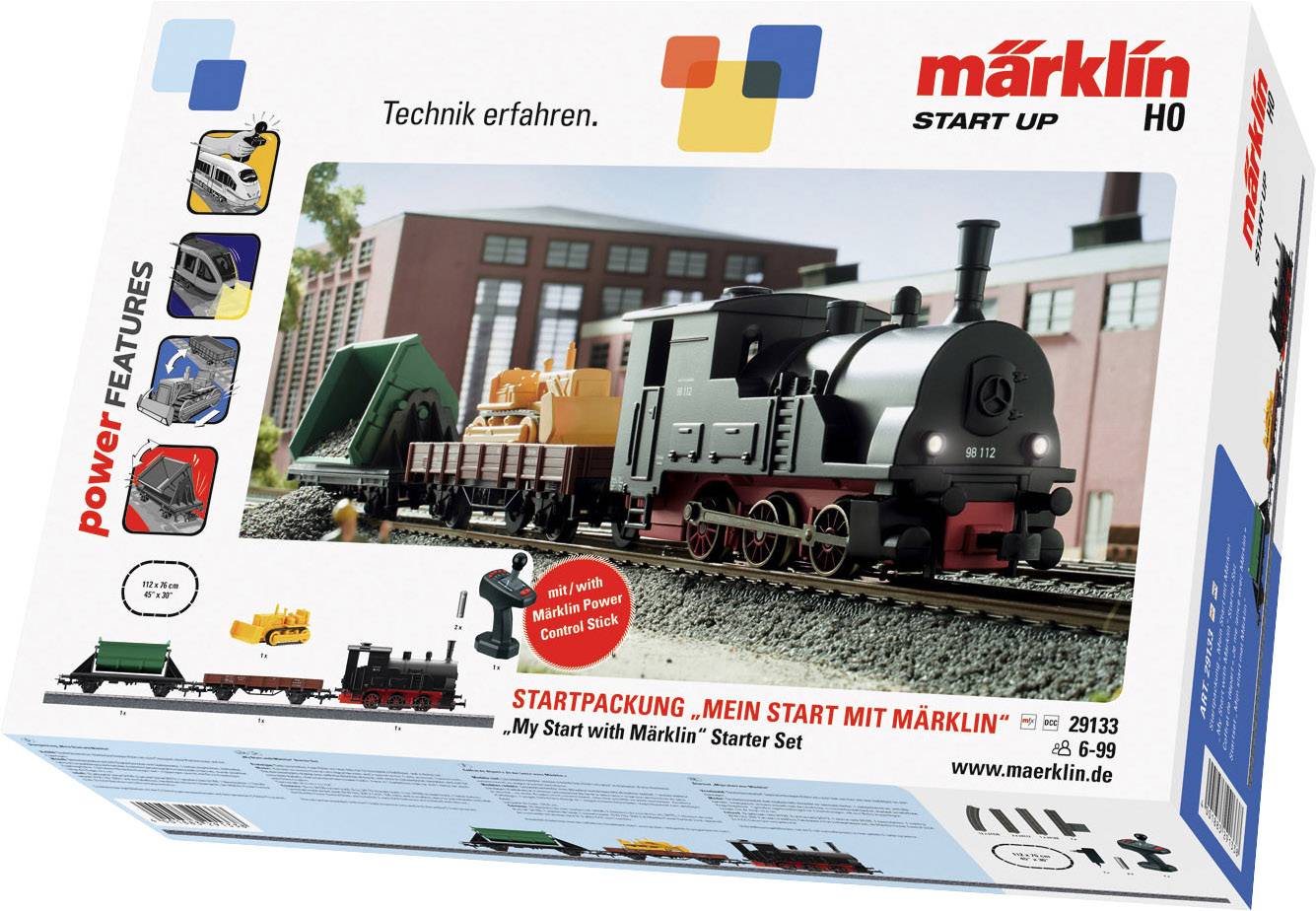 Pack de démarrage avec train miniature, rails et accessoires ; Slogan 'Découvrir la technique' ; comprend une télécommande et un camion porte-conteneurs.