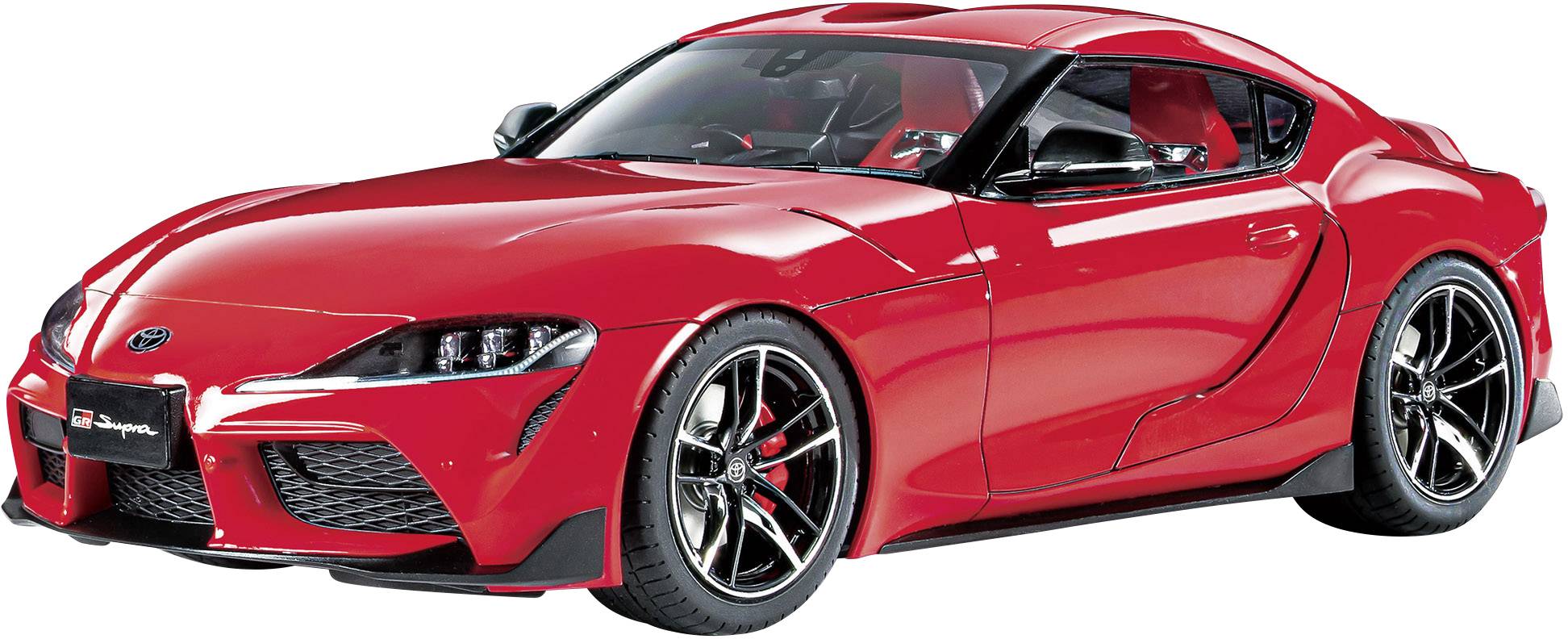 Une voiture de sport rouge au design aérodynamique et à la carrosserie basse. Des jantes sportives et des freins ventilés sont visibles.