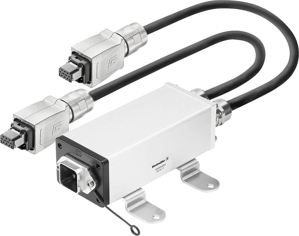 Un dispositif rectangulaire métallique avec des connexions par câbles aux deux extrémités, probablement un connecteur ou un adaptateur industriel.