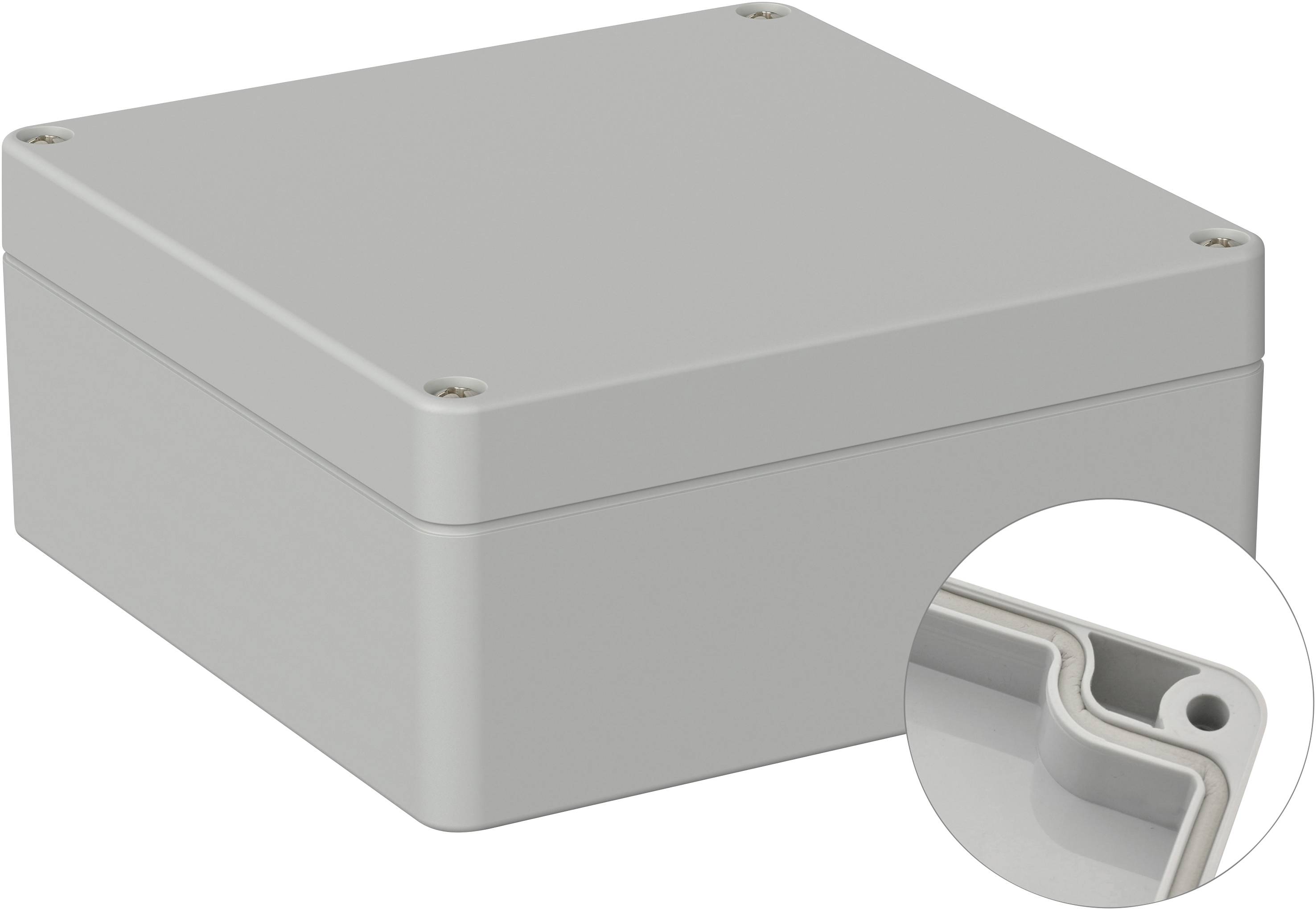 Boîtier en plastique gris, rectangulaire, avec des coins arrondis et des vis à chaque angle. Un gros plan montre le bord intérieur.