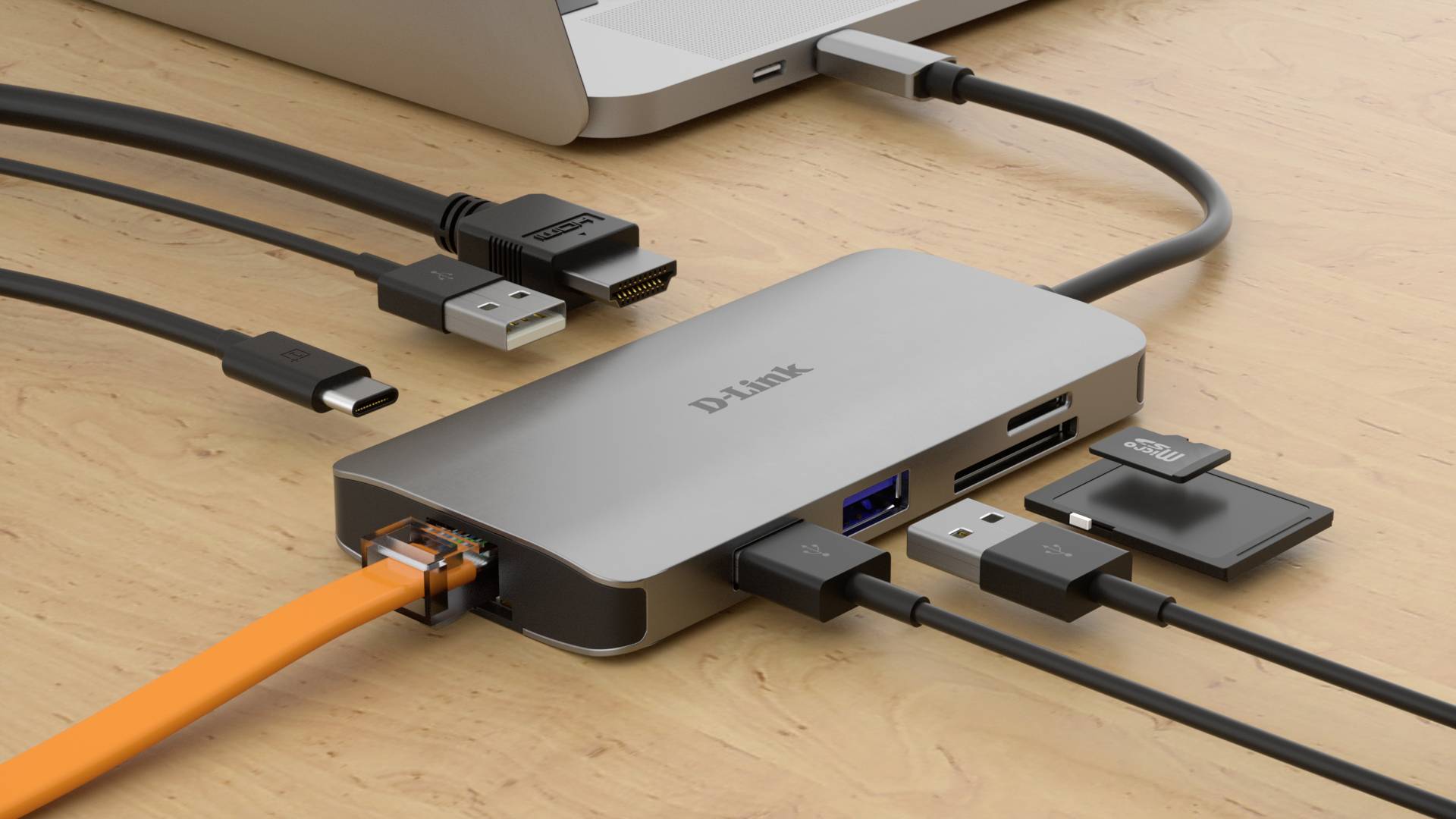 Ordinateur portable connecté à un hub USB-C. Le hub dispose de plusieurs ports : HDMI, USB, Ethernet, lecteur de cartes SD et lecteur de cartes MicroSD.