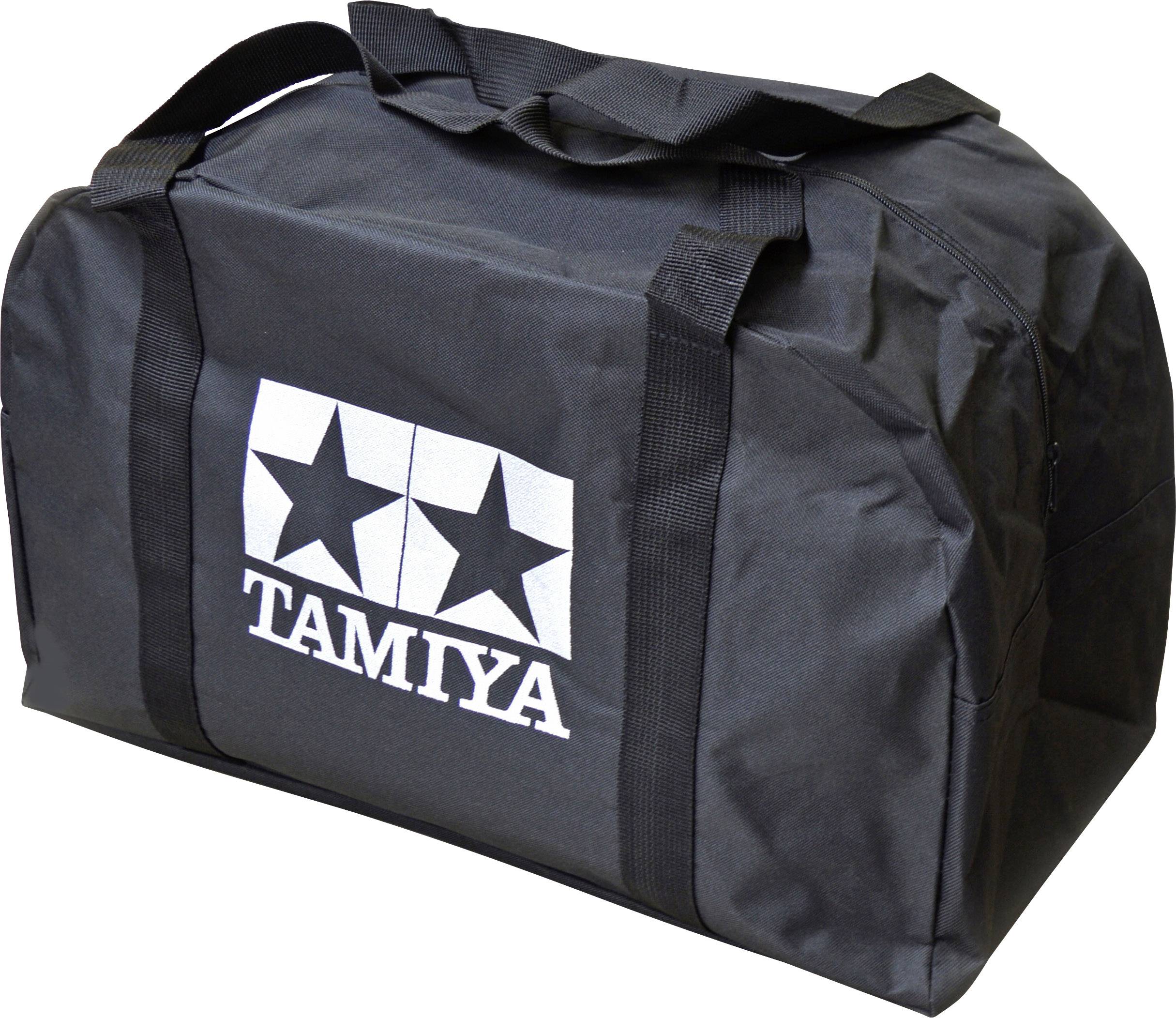 Sac de sport noir avec deux poignées et le logo Tamiya blanc sur le côté, composé de deux étoiles et du lettrage 'TAMIYA'.
