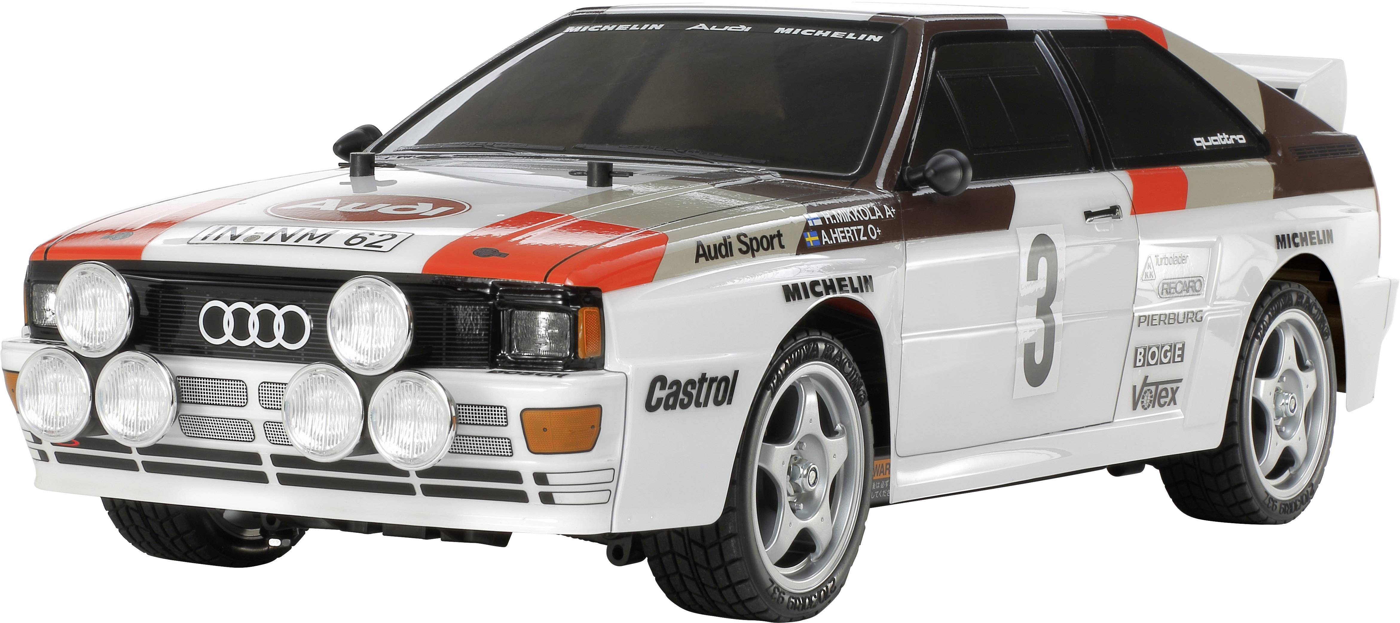 Une voiture miniature d'une voiture de rallye au design rétro, principalement blanche avec des accents noirs et rouges, portant le numéro de course 3 et plusieurs logos.