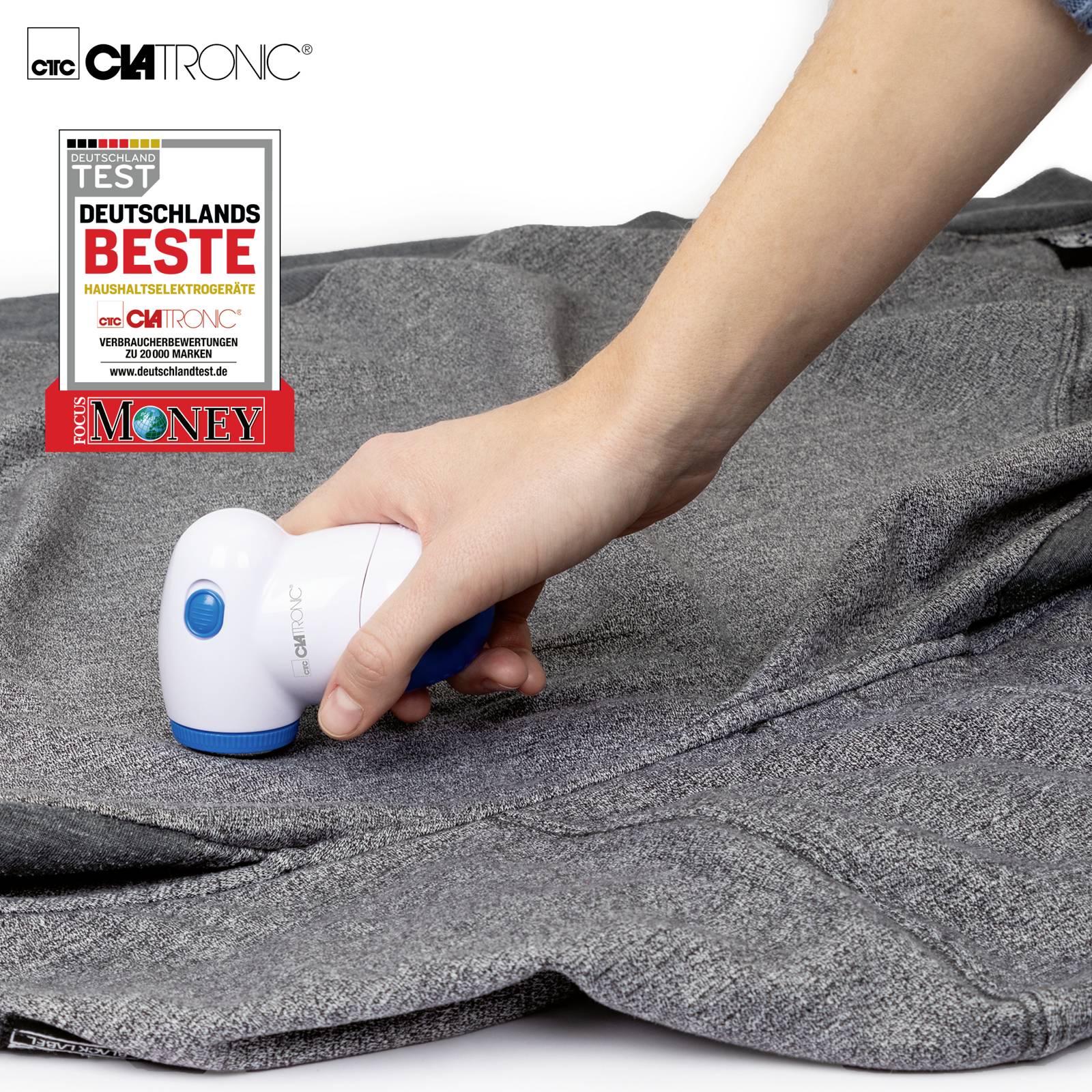 Une main tient un épilateur anti-peluches électrique et enlève les peluches d'un tissu gris. Un sceau indique 'Meilleur d'Allemagne'.