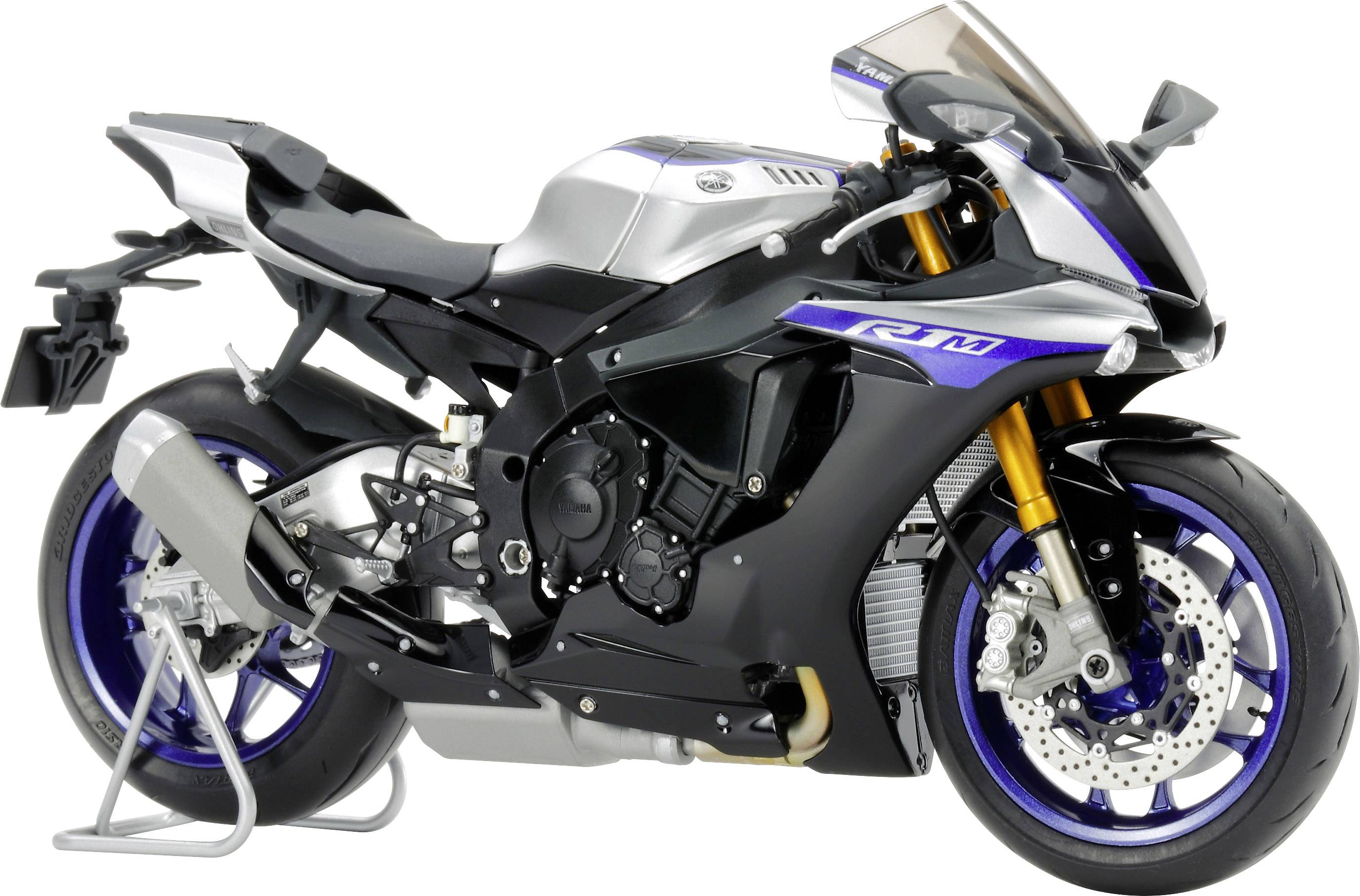 Une moto de sport au design élancé et aux accents bleus est posée sur un support. Elle est équipée de grands disques de frein et présente une forme aérodynamique.