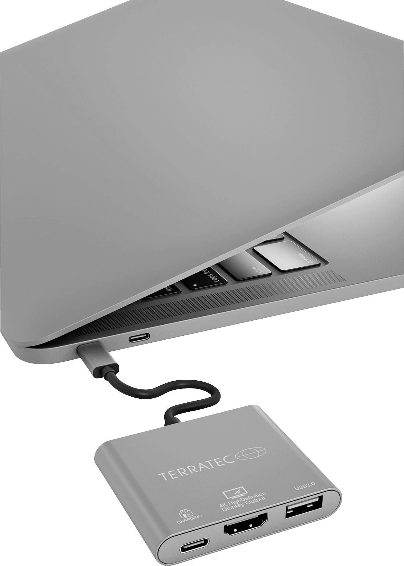 Ordinateur portable avec un coin ouvert, connecté à un adaptateur USB-C Terratec. L'adaptateur dispose des ports HDMI, USB-C et USB.