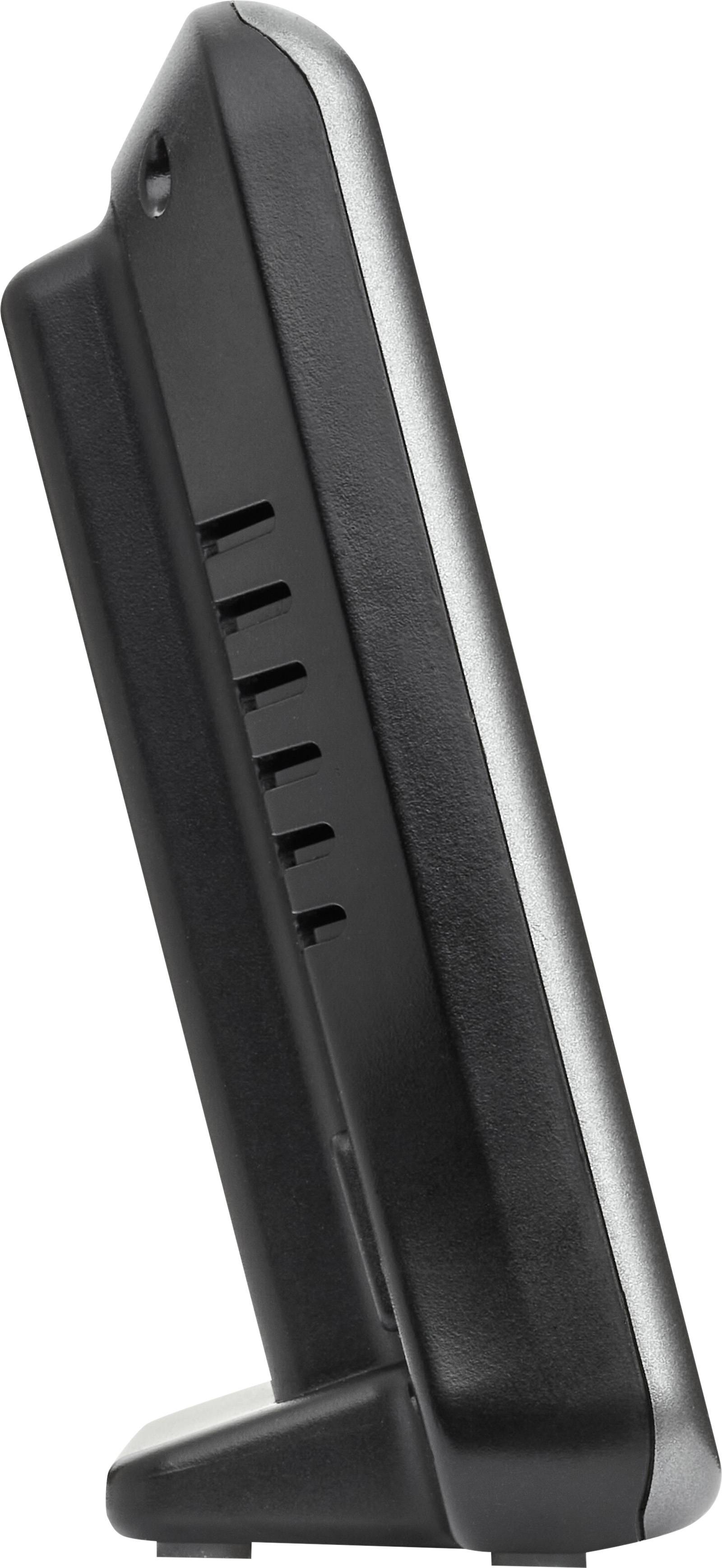 Appareil noir, rectangulaire, debout, avec des fentes de ventilation sur les côtés, vue de profil.