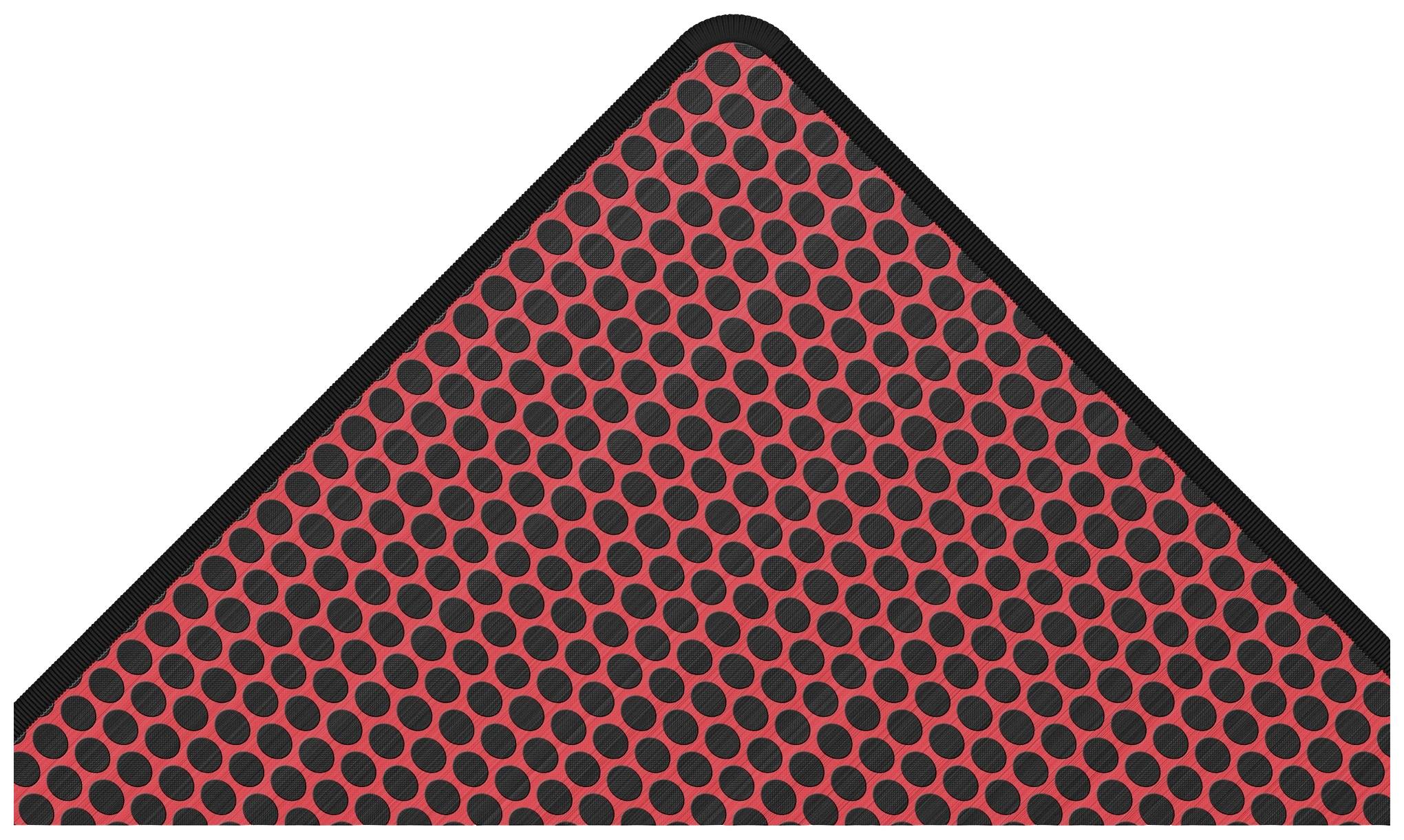 Un panneau de signalisation triangulaire présente un motif de points rouges et noirs.