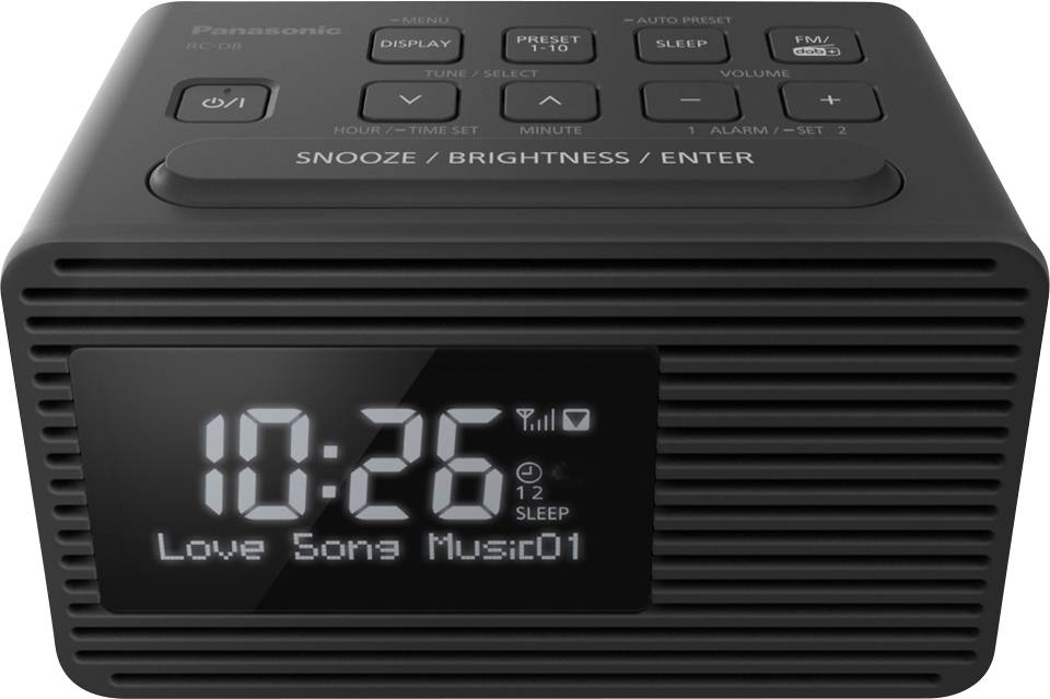 Réveil-radio noir avec affichage numérique. Indique l'heure 10:26, diffuse 'Love Song Music01'. Touches de fonctions en haut.