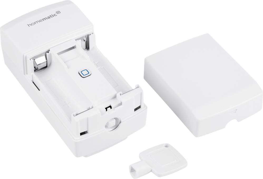 Un appareil électronique blanc avec son couvercle retiré et une clé à côté. L'appareil semble être un module.