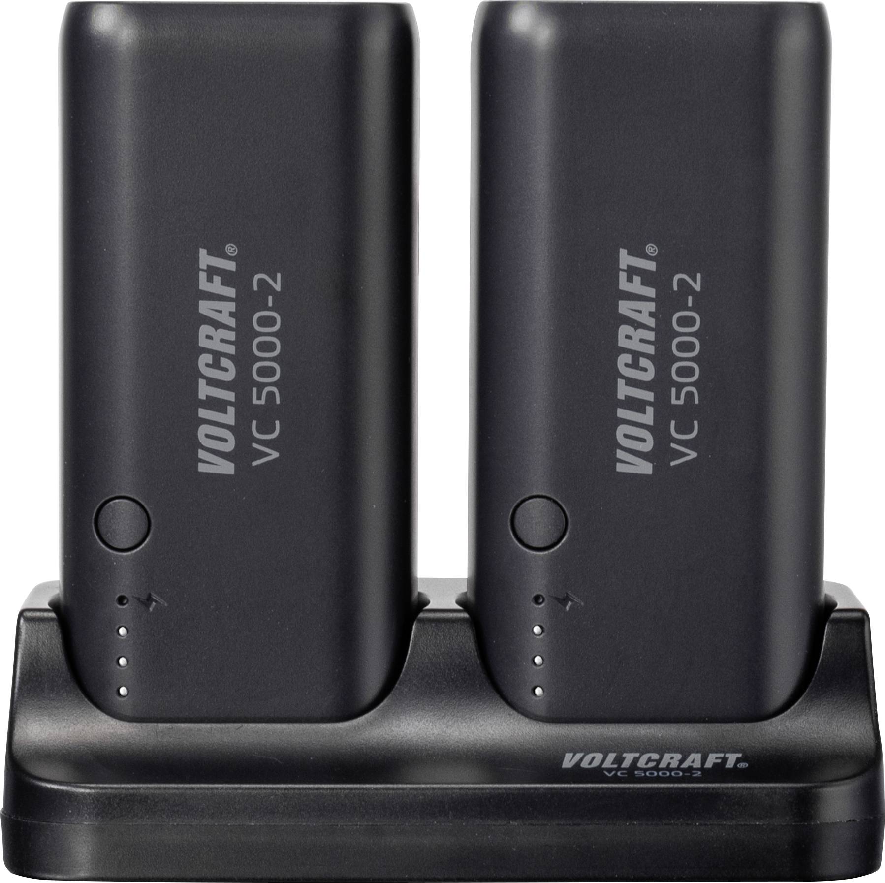 Deux batteries noires 'Voltcraft VC 5000-2' posées sur un chargeur, avec des voyants LED.