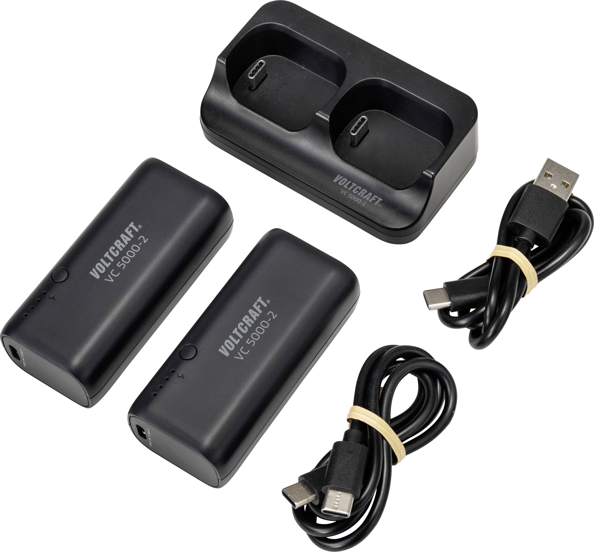 Un ensemble chargeur avec deux batteries rechargeables et des câbles USB. Les batteries sont étiquetées 'VOLTCraft VC 9800-2'.