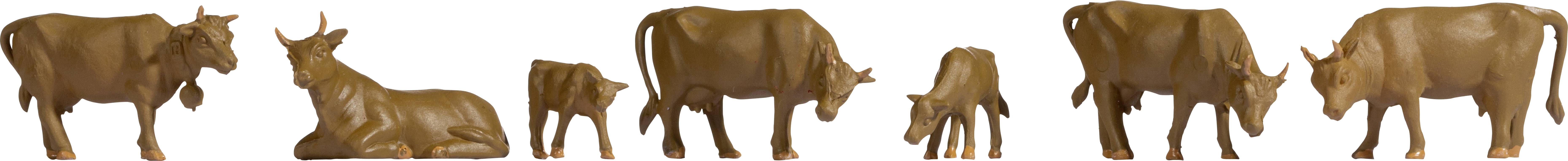 Six vaches en chocolat dans différentes positions et tailles, toutes réalisées en chocolat brun, sur un fond blanc.