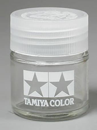 Un petit flacon à vis, portant le logo de Tamiya Color avec deux étoiles blanches. Récipient pour peinture de maquette.