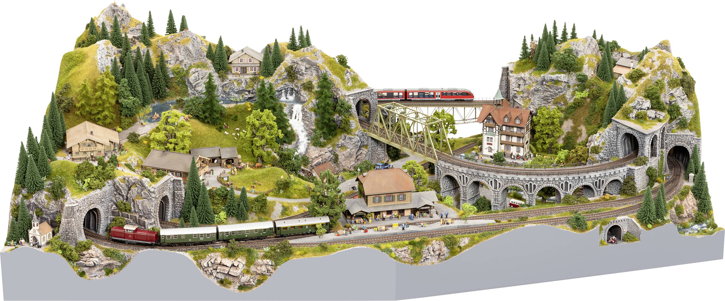 Un paysage détaillé de train miniature montre des trains circulant à travers des montagnes, des tunnels et des ponts. Entouré d'arbres et de bâtiments.