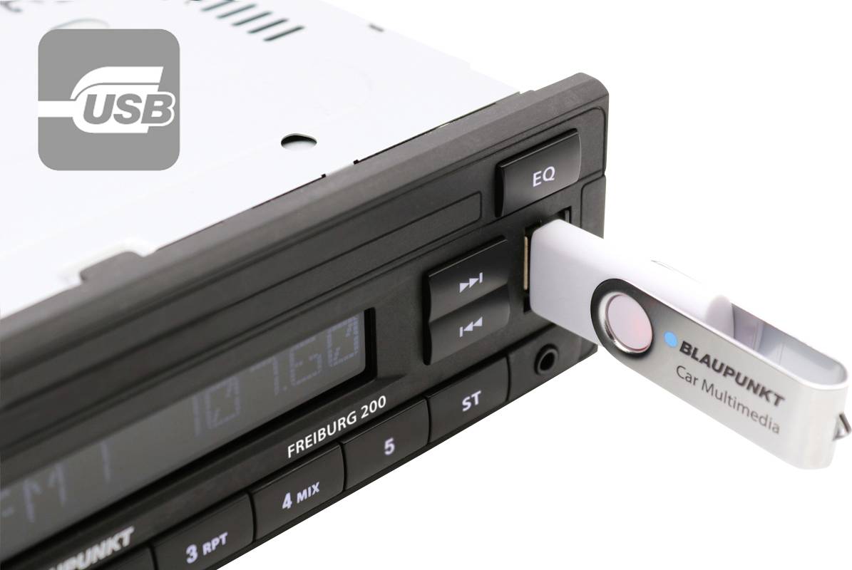 Un autoradio avec une clé USB branchée. La clé est de Blaupunkt et porte l'inscription 'Car Multimedia'.
