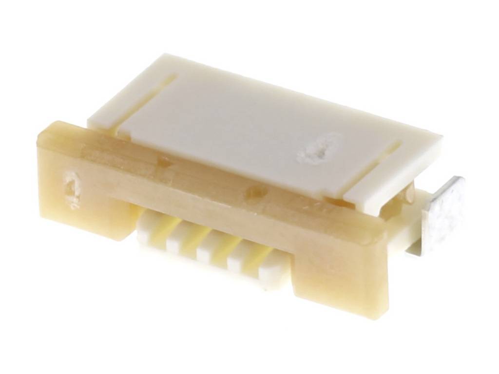 Un petit connecteur électronique rectangulaire avec six points de connexion dans un boîtier en plastique beige et blanc.