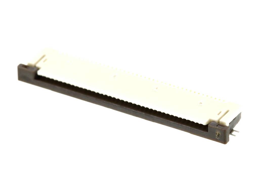 Un connecteur électrique beige-brun, plat et rectangulaire, est utilisé en électronique pour relier différents composants.