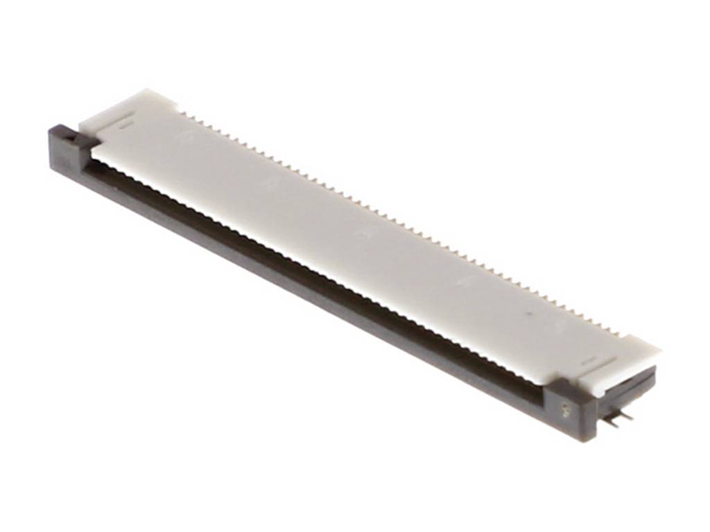 Un connecteur électronique coudé avec des composants blancs et noirs, posé sur une surface blanche.