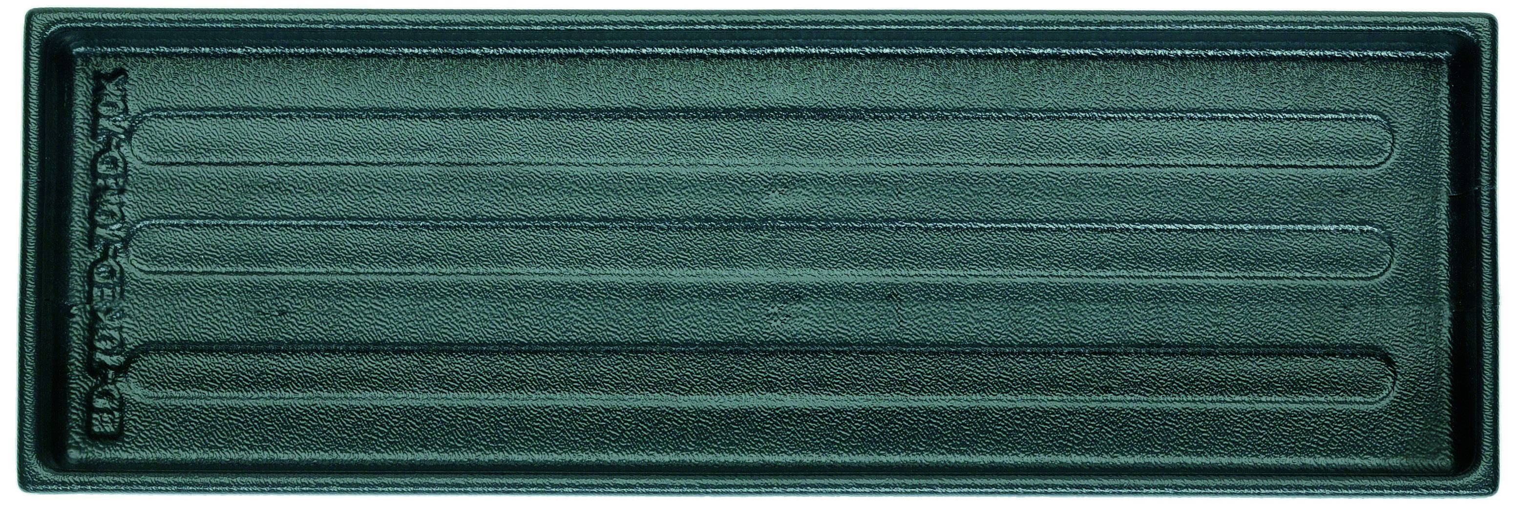 Un bac rectangulaire en plastique vert avec plusieurs rainures sur sa surface.