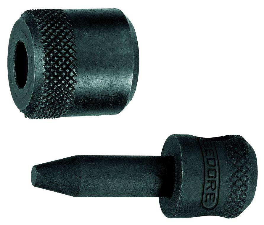 Deux outils noirs en métal : Un tampon rond à pointe aiguë et une pièce cylindrique au bord cannelé.