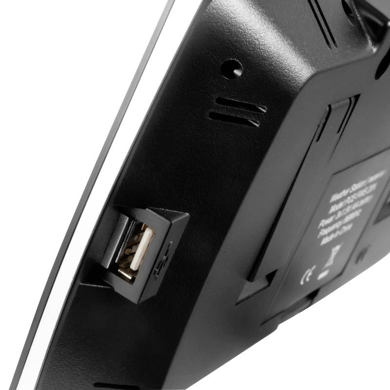 Appareil noir avec port USB, vue de profil. Détails techniques, aucune marque ou nom identifiable.