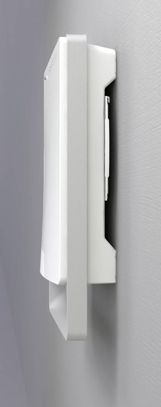 Un appareil blanc rectangulaire est monté sur le côté d'un mur gris.