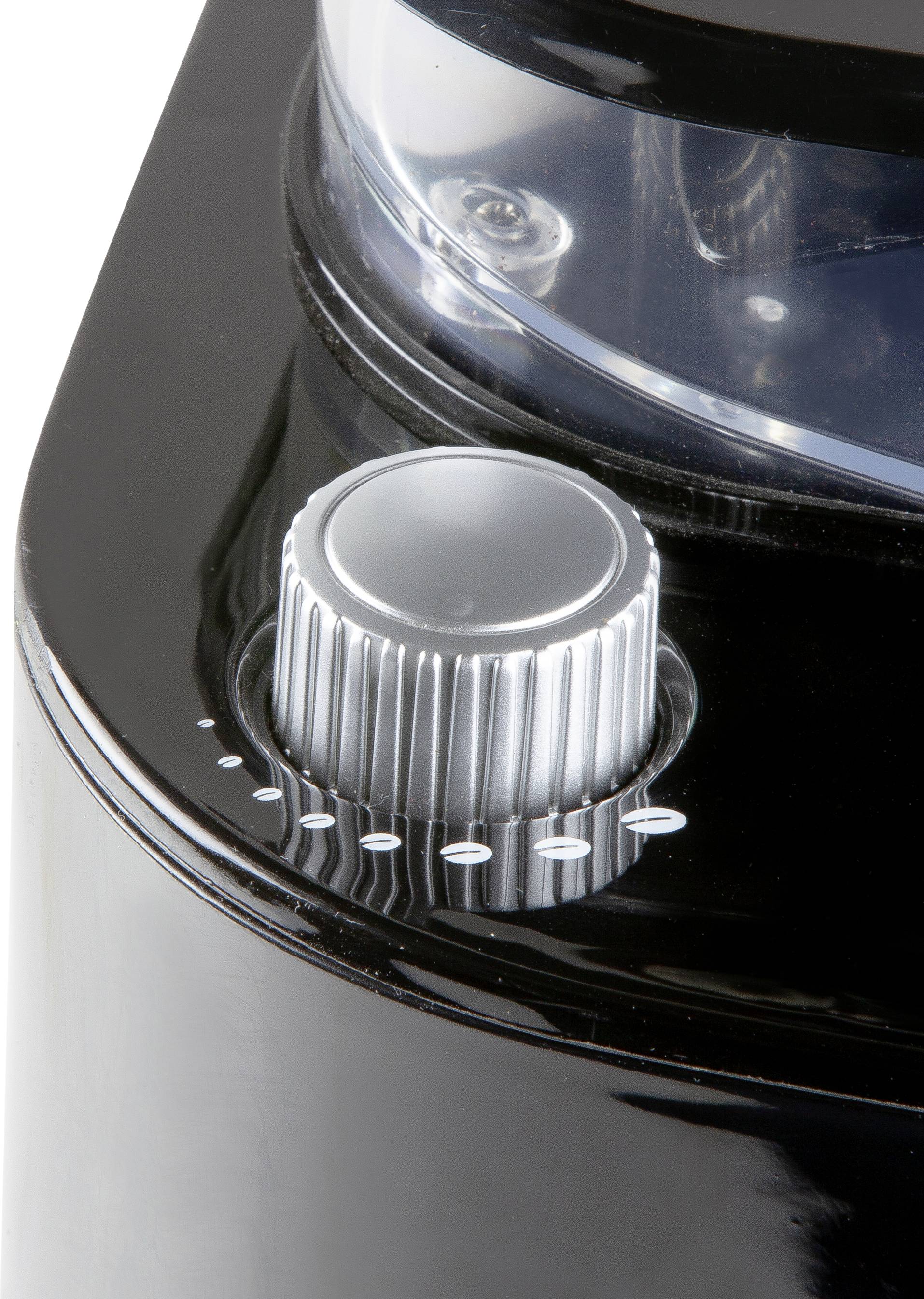 Gros plan sur un bouton rotatif d'un appareil noir, probablement utilisé pour les réglages ou le contrôle.