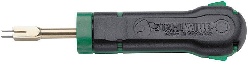 Outil avec une poignée noire et un embout métallique, utilisé pour desserrer ou fixer des fiches dans des connexions électriques.